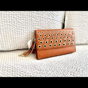 Tan clutch purse with gold circle accents